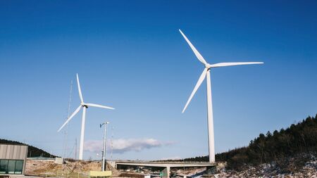 wind turbine in field and meadow on mountain with beauty blue sky and cloudy background in South...