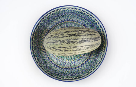 Melon from Uzbekistan is on a plate with Uzbek ornament.の写真素材