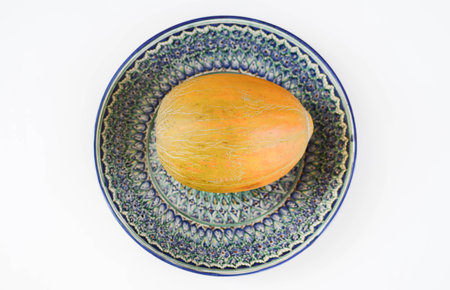 Melon from Uzbekistan is on a plate with Uzbek ornament.の写真素材