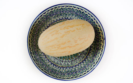 Melon from Uzbekistan is on a plate with Uzbek ornament.の写真素材