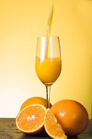 Orange Juice Splashing on Vintage Wood Tableの写真素材