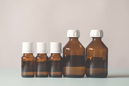 bottles of medicine lined up on a white background. Chemical experiments, vaccines, blood testsの写真素材