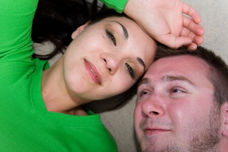 happy couple lying on floorの写真素材