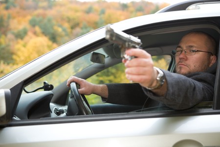 angry man with gun driving car