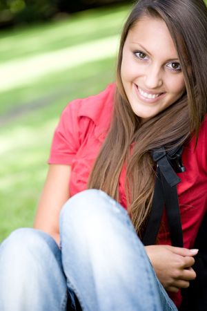 happy young woman learning in parkの写真素材