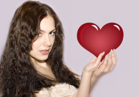 Beautiful girl with the heart in her handsの写真素材