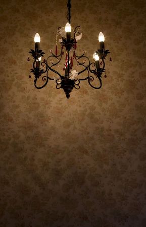 Iinterior scene of old chandelier over the wall with flowered patternの写真素材