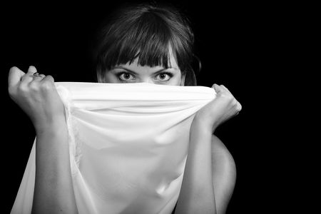 Young woman with white veil over the black backgroundの写真素材