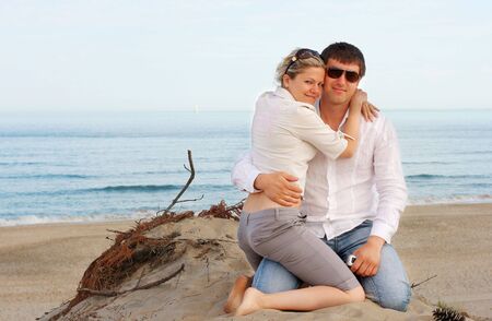 Young couple hugging at the beachの写真素材
