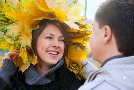 Happy young couple with autumn maple leaves in the park 
の写真素材