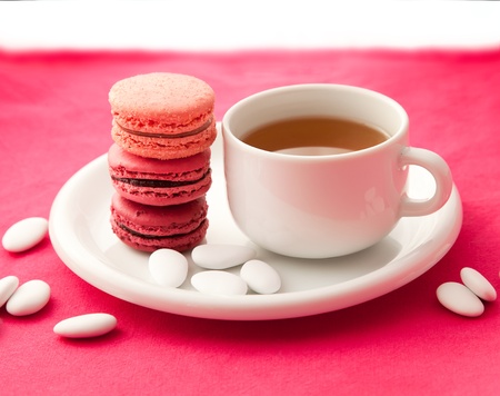 Colorful macarons with a cup of teaの写真素材