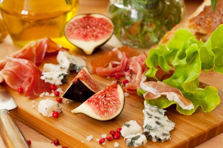 Ham, cheese and figs on the wooden boardの写真素材