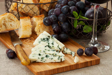 Blue cheese with a glass of red wineの写真素材