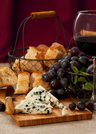 Blue cheese with a glass of red wineの写真素材