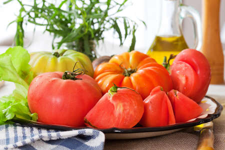 Ripe tomatoes with olive oilの写真素材