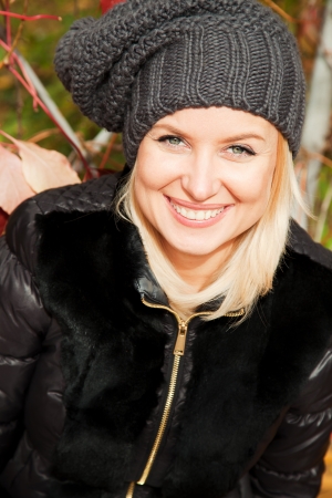 Beautiful blonde woman in the autumn parkの写真素材