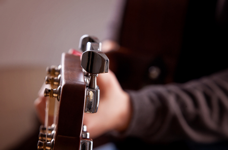 Close-up of woman playing acoustic guitarの写真素材