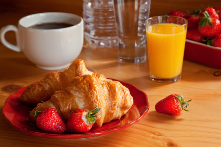 Tasty breakfast with croissants and strawberriesの写真素材