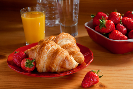 Tasty breakfast with croissants and strawberriesの写真素材