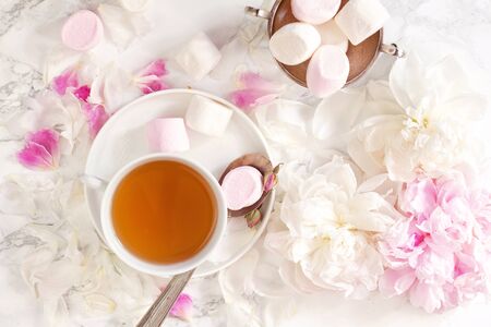 Beautiful still life with tea cup and peonies.Top viewの写真素材