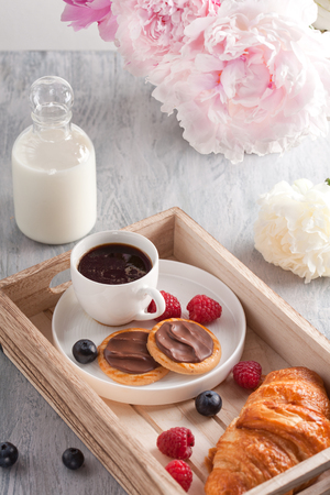 Romantic breakfast with coffee, croissant, chocolate cookies and berriesの写真素材