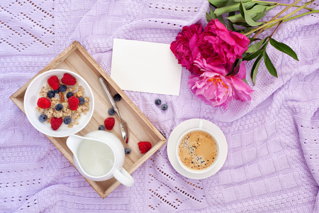 Breakfast with coffee, granola, berries and milkの写真素材