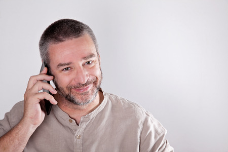 Mature man talking over the cell phoneの写真素材