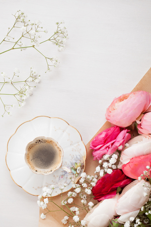 Top view to pink flowers and cup of coffee の写真素材