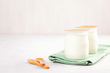 Industrial natural yogurt in plastic cans. Healthy and fast breakfast conceptの写真素材