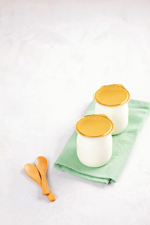 Industrial natural yogurt in plastic cans. Healthy and fast breakfast conceptの写真素材