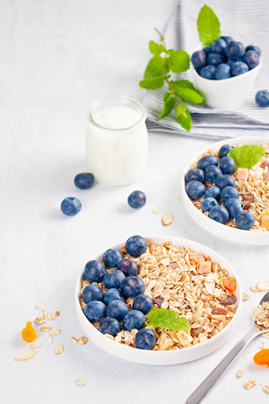 Homemade granola or oatmeal muesli with nuts, dried fruits and fresh berries. Healty diet breakfast, vegeterian food conceptの写真素材
