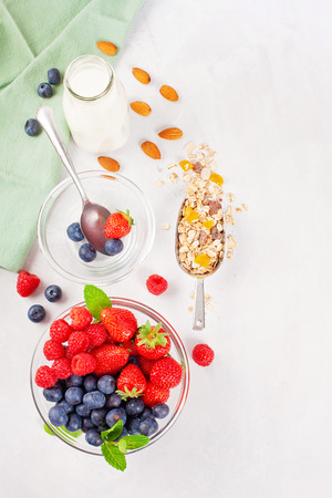 Homemade granola or oatmeal muesli with nuts, dried fruits and fresh berries. Healty diet breakfast, vegeterian food conceptの写真素材