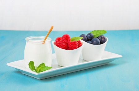 Yogurt with blueberries and raspberies - health and diet concept. Balanced healthy breakfastの写真素材