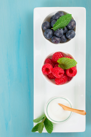 Yogurt with blueberries and raspberies - health and diet concept. Balanced healthy breakfastの写真素材