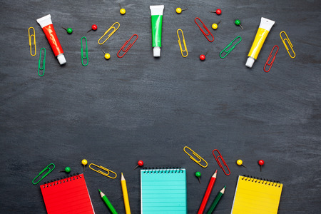 Back to school concept with colorful stationary over the blackboard backgroundの写真素材