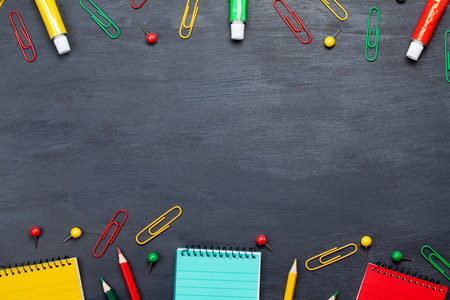 Back to school concept with colorful stationary over the blackboard backgroundの写真素材