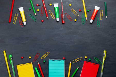 Back to school concept with colorful stationary over the blackboard backgroundの写真素材