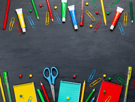 Back to school concept with colorful stationary over the blackboard backgroundの写真素材