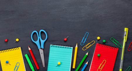 Back to school concept with colorful stationary over the blackboard backgroundの写真素材