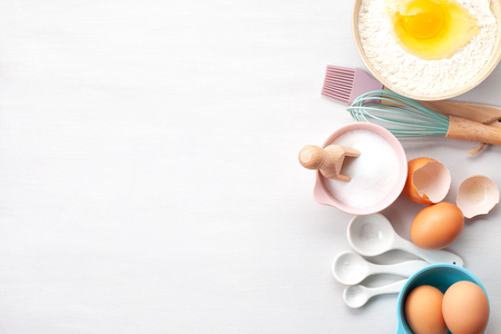 Baking utensils and cooking ingredients for tarts, cookies, dough and pastry. Flat lay with eggs, flour, sugar, berries.Top view, mockup for recipe, culinary classes, cooking blog.の写真素材