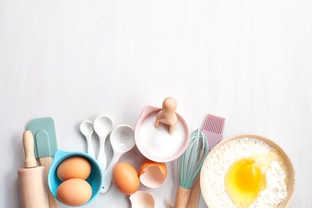 Baking utensils and cooking ingredients for tarts, cookies, dough and pastry. Flat lay with eggs, flour, sugar, berries.Top view, mockup for recipe, culinary classes, cooking blog.の写真素材