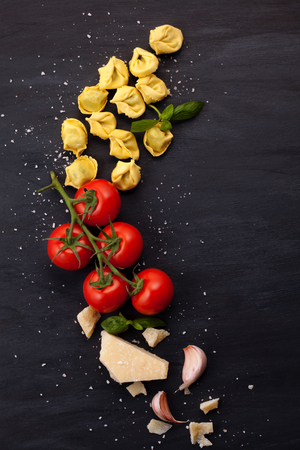 Italian pasta with cheese, basil and tomatoes. Fresh organic food conceptの写真素材