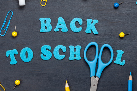 Back to school text with colorful stationary over the blackboard backgroundの写真素材