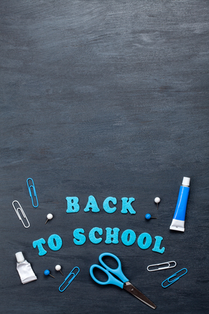 Back to school text with colorful stationary over the blackboard backgroundの写真素材