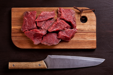 Raw fresh meat on wooden board ready for cookingの写真素材