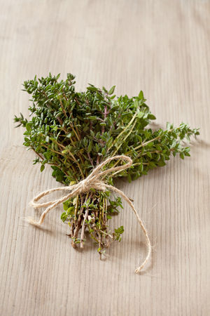 Bunch of fresh organic thyme on a wooden backgroundの写真素材