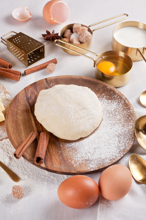 Dough preparation recipe for bread, pizza, pasta, cookies or pie ingridients, food flat lay on kitchen table background. Working with butter, milk, yeast, flour, eggs, sugar pastry or bakery cooking.の写真素材