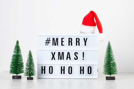 Christmas greeting card mock up. Light box with the text Merry Xmas and Christmas decoration. Seasons greetings conceptの写真素材
