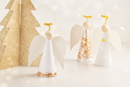 Christmas greeting card mock up with paper angel and christmas tree and decoration.の写真素材