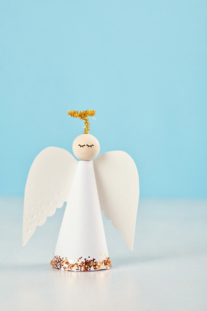 Christmas greeting card mock up with paper angel and christmas tree and decoration.の写真素材